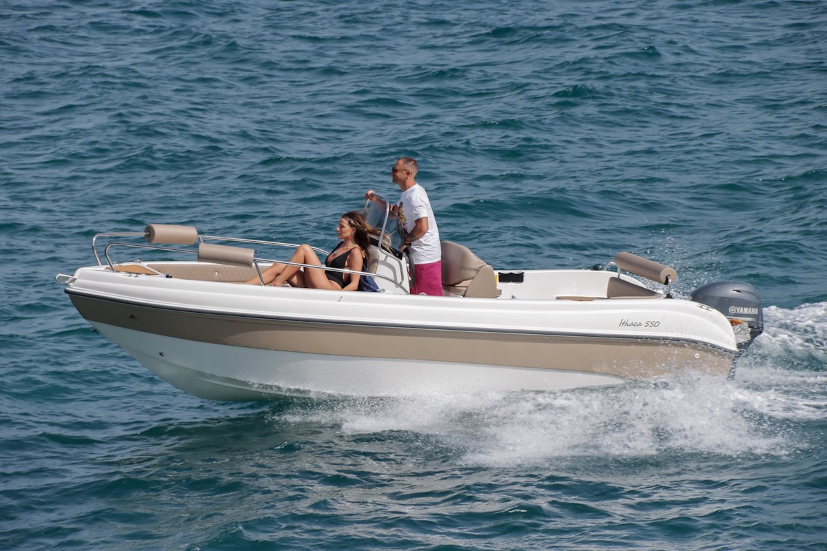 Carel Ithaca 550 self-drive boat with two people cruising on the Ionian Sea near Corfu